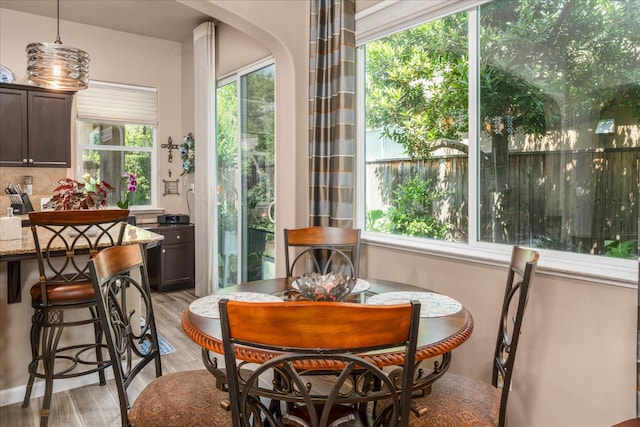 3675 Trenton Ln, Clovis, CA 93619 - dining area featuring light wood-style floors and arched walkways
