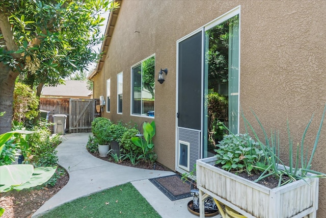 3675 Trenton Ln, Clovis, CA 93619 - view of exterior entry with stucco siding and a gate