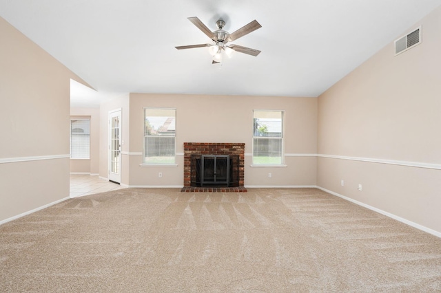 6051 N Tracy Ave, Fresno, CA 93722 - unfurnished living room with ceiling fan, carpet, baseboards, and a brick fireplace