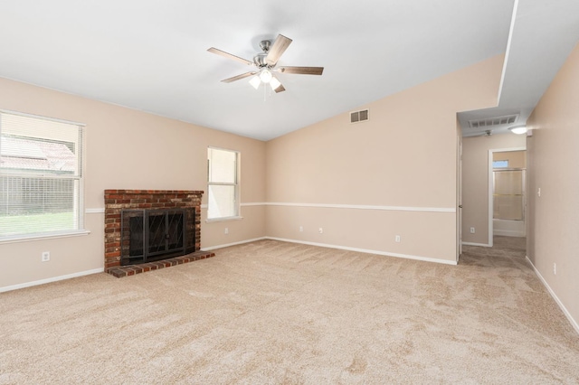 6051 N Tracy Ave, Fresno, CA 93722 - unfurnished living room featuring a ceiling fan, carpet floors, a brick fireplace, baseboards, and vaulted ceiling