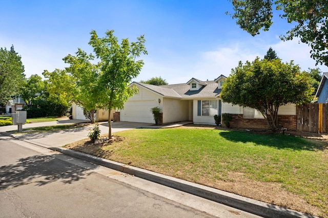 6051 N Tracy Ave, Fresno, CA 93722 - view of front of property with a garage, concrete driveway, and brick siding