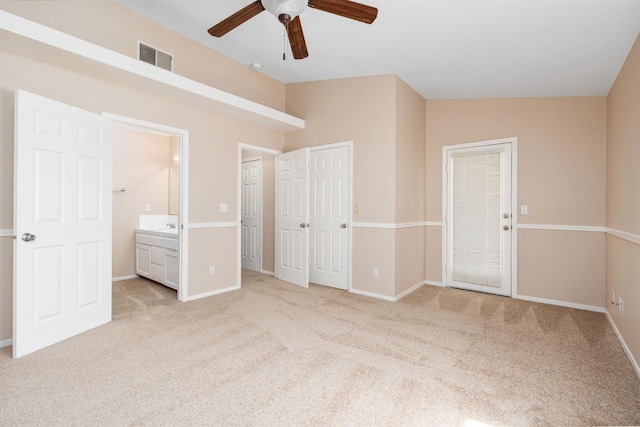6051 N Tracy Ave, Fresno, CA 93722 - unfurnished bedroom with light carpet, connected bathroom, baseboards, and ceiling fan