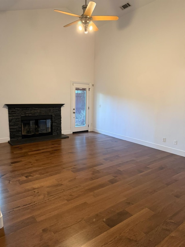 9850 N Winery Ave, Fresno, CA 93720 - unfurnished living room featuring baseboards, a fireplace, a high ceiling, dark wood finished floors, and a ceiling fan