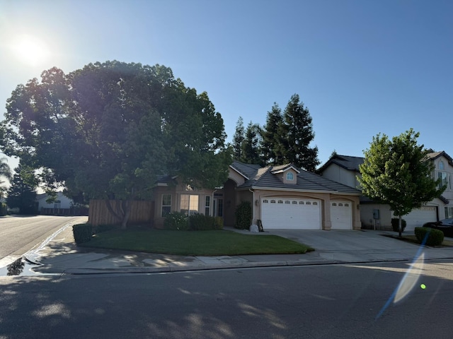 9850 N Winery Ave, Fresno, CA 93720 - ranch-style home with an attached garage, concrete driveway, stucco siding, and a tiled roof