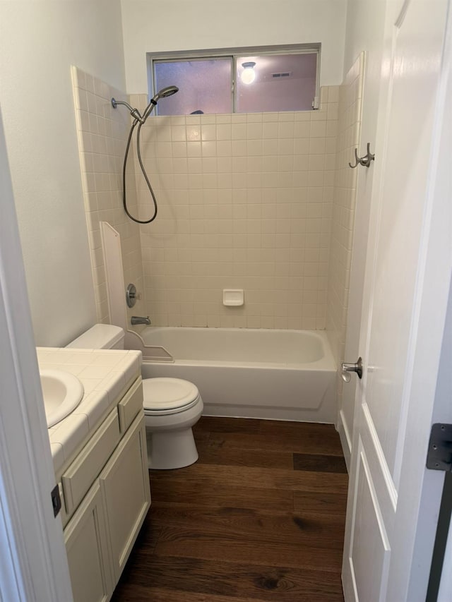 9850 N Winery Ave, Fresno, CA 93720 - bathroom with vanity, wood finished floors, toilet, and washtub / shower combination