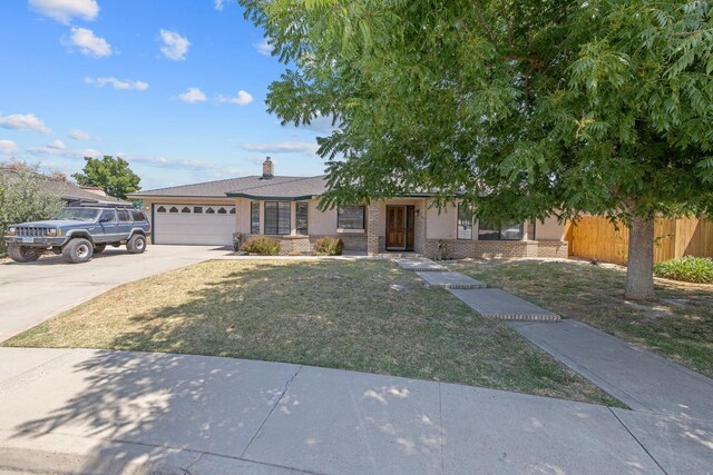 300 W Adrian Way, Hanford, CA 93230 - ranch-style house with a garage, driveway, brick siding, and a chimney