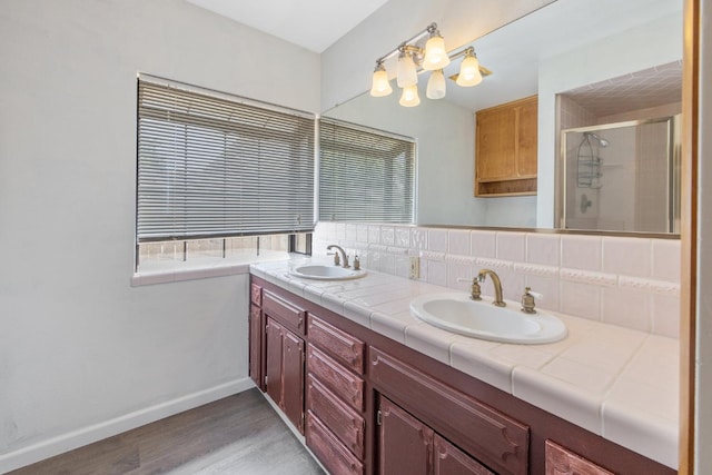 300 W Adrian Way, Hanford, CA 93230 - full bath with a chandelier, double vanity, wood finished floors, a stall shower, and baseboards