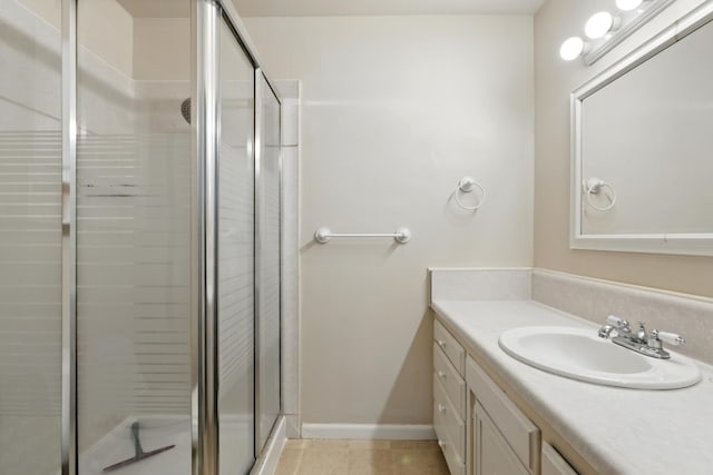 4849 N 7th St Unit E, Fresno, CA 93726 - full bathroom featuring vanity, a stall shower, tile patterned floors, and baseboards