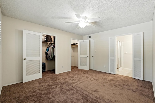 4849 N 7th St Unit E, Fresno, CA 93726 - unfurnished bedroom with carpet, ensuite bath, a textured ceiling, a ceiling fan, and multiple closets