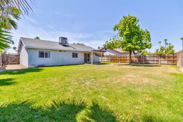 1226 Summer Field Dr, Hanford, CA 93230 - rear view of property featuring stucco siding and central AC