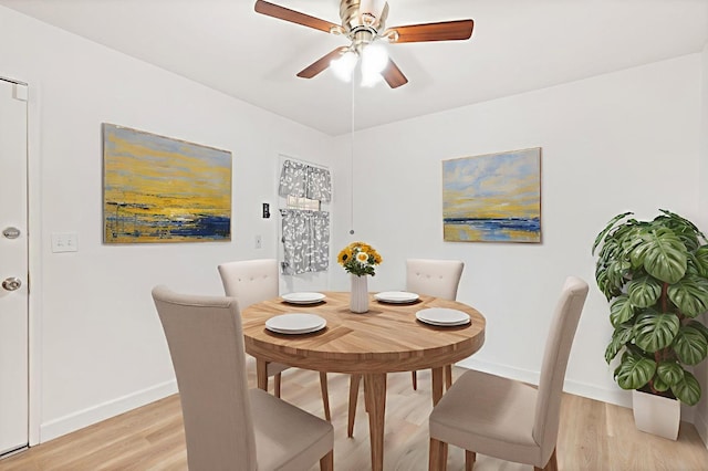 4003 E El Monte Way, Fresno, CA 93702 - dining room featuring a ceiling fan, baseboards, and light wood-style flooring