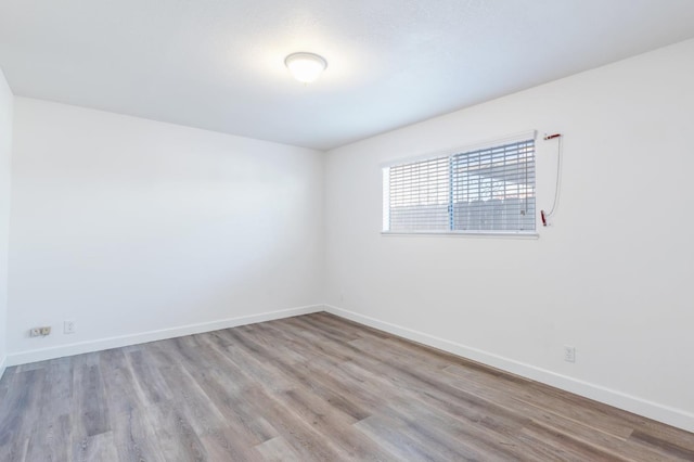 4003 E El Monte Way, Fresno, CA 93702 - empty room with baseboards and wood finished floors