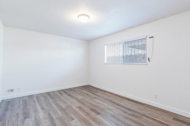 4003 E El Monte Way, Fresno, CA 93702 - empty room with baseboards and wood finished floors