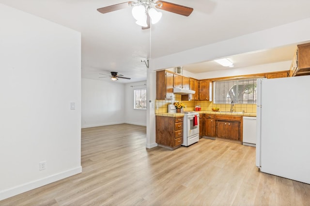 4003 E El Monte Way, Fresno, CA 93702 - kitchen featuring white appliances, under cabinet range hood, ceiling fan, light wood-type flooring, and tasteful backsplash