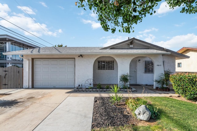 4003 E El Monte Way, Fresno, CA 93702 - view of front of property with driveway, stucco siding, and an attached garage