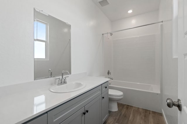 3210 Frontera Ave, Clovis, CA 93619 - bathroom with toilet, vanity, tub / shower combination, and wood finished floors