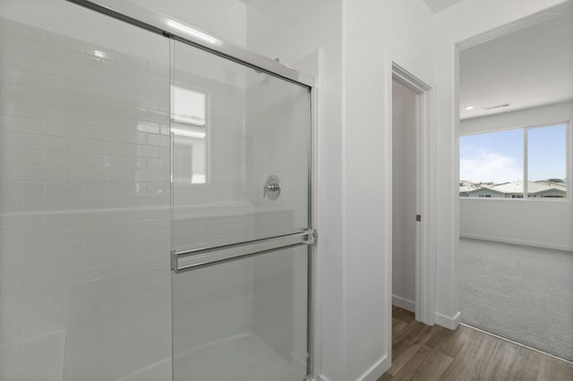 3210 Frontera Ave, Clovis, CA 93619 - full bathroom featuring baseboards, a stall shower, and wood finished floors