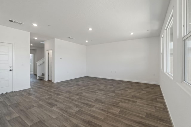 3210 Frontera Ave, Clovis, CA 93619 - spare room featuring recessed lighting, dark wood-style flooring, baseboards, healthy amount of natural light, and stairway