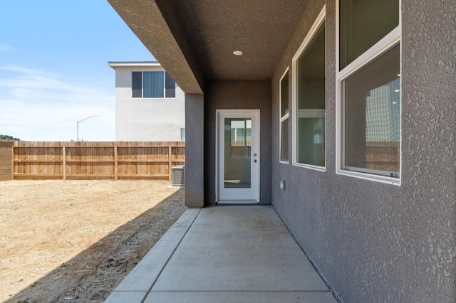 3210 Frontera Ave, Clovis, CA 93619 - doorway to property with stucco siding, a patio, and central AC