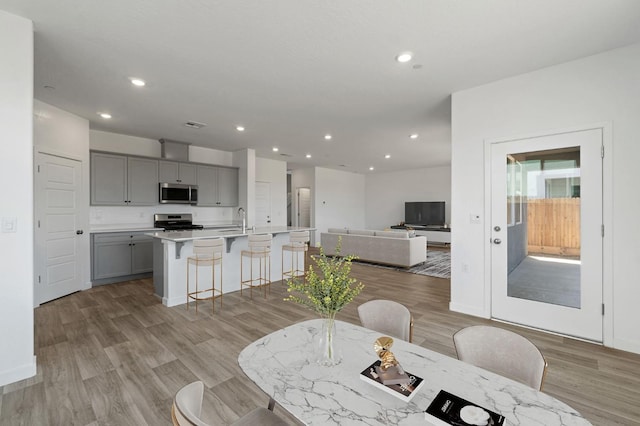 3210 Frontera Ave, Clovis, CA 93619 - dining area with light wood-style floors, recessed lighting, and baseboards