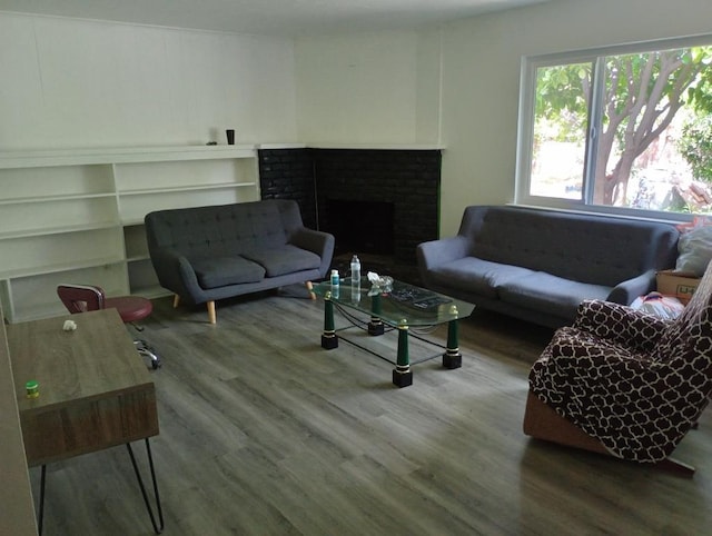 4531 E Fedora Ave, Fresno, CA 93726 - living area featuring wood finished floors and a brick fireplace