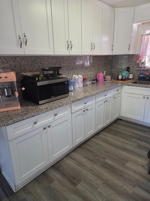 4531 E Fedora Ave, Fresno, CA 93726 - kitchen featuring stainless steel microwave, white cabinets, a sink, and tasteful backsplash
