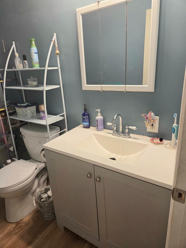 4531 E Fedora Ave, Fresno, CA 93726 - half bathroom featuring vanity, wood finished floors, and toilet