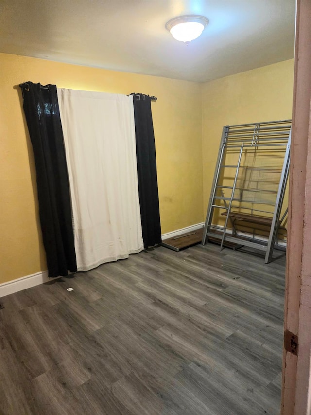 4531 E Fedora Ave, Fresno, CA 93726 - unfurnished room with baseboards and dark wood-type flooring