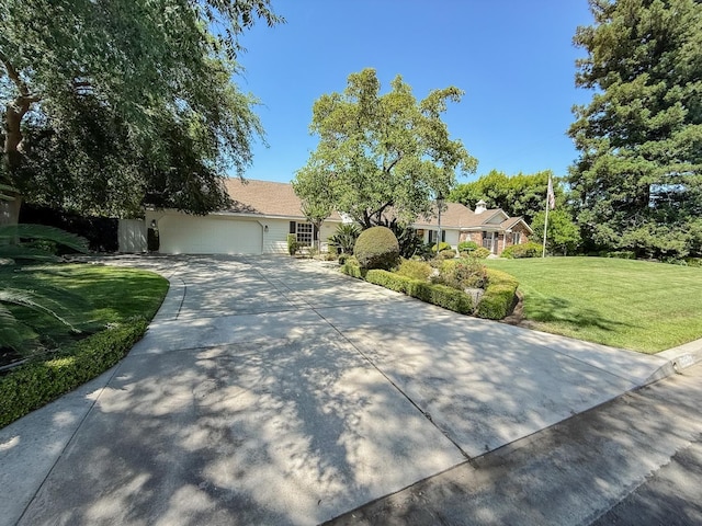 2210 W Spruce Ave, Fresno, CA 93711 - view of front of property featuring concrete driveway, a front lawn, and an attached garage