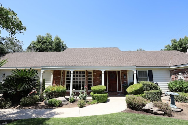 2210 W Spruce Ave, Fresno, CA 93711 - ranch-style house with brick siding, a porch, and a shingled roof