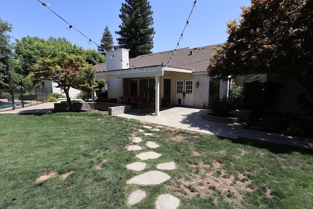 2210 W Spruce Ave, Fresno, CA 93711 - rear view of property featuring a patio, a chimney, and stucco siding