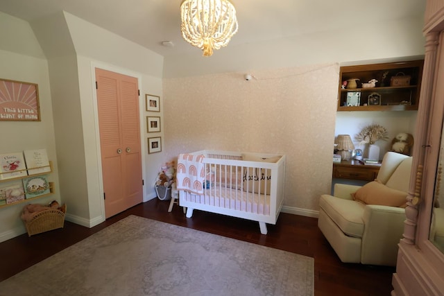 2210 W Spruce Ave, Fresno, CA 93711 - bedroom with wood finished floors, a chandelier, a nursery area, and baseboards