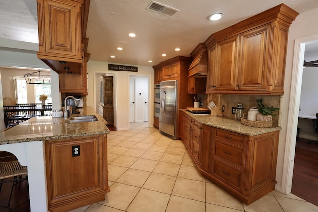 2210 W Spruce Ave, Fresno, CA 93711 - kitchen featuring a sink, stainless steel appliances, custom range hood, brown cabinetry, and recessed lighting