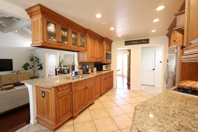2210 W Spruce Ave, Fresno, CA 93711 - kitchen featuring a sink, appliances with stainless steel finishes, brown cabinetry, light stone counters, and recessed lighting