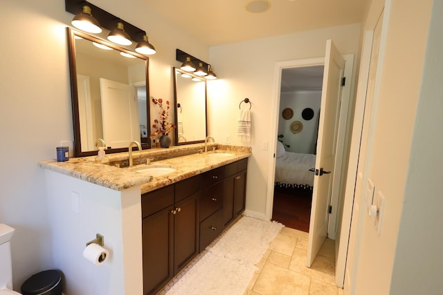2210 W Spruce Ave, Fresno, CA 93711 - ensuite bathroom with double vanity, toilet, and tile patterned flooring