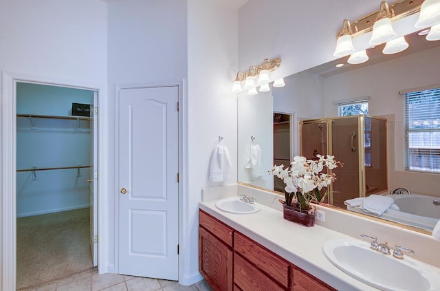 2671 E Eclipse Ave, Fresno, CA 93720 - full bathroom featuring a shower stall, a bath, double vanity, tile patterned floors, and a walk in closet
