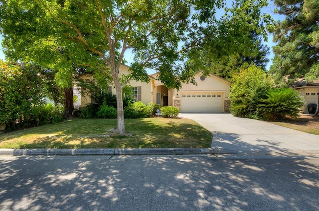 2671 E Eclipse Ave, Fresno, CA 93720 - obstructed view of property featuring concrete driveway, a front lawn, an attached garage, and stone siding
