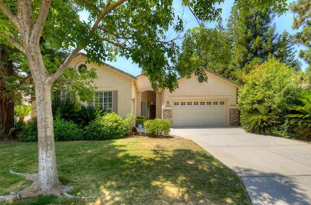 2671 E Eclipse Ave, Fresno, CA 93720 - view of front of property featuring an attached garage, concrete driveway, a front lawn, and stucco siding