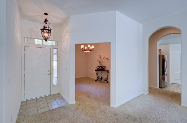 2671 E Eclipse Ave, Fresno, CA 93720 - carpeted entrance foyer featuring a chandelier, arched walkways, and healthy amount of natural light