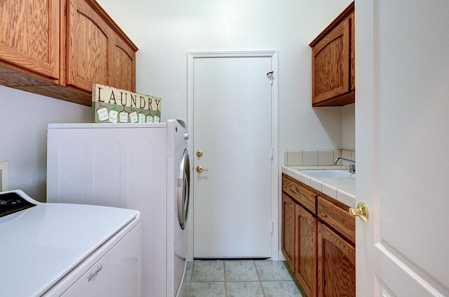 2671 E Eclipse Ave, Fresno, CA 93720 - laundry area featuring cabinet space, washing machine and clothes dryer, and light tile patterned flooring