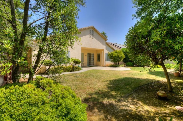 2671 E Eclipse Ave, Fresno, CA 93720 - rear view of house with a lawn, stucco siding, and a patio
