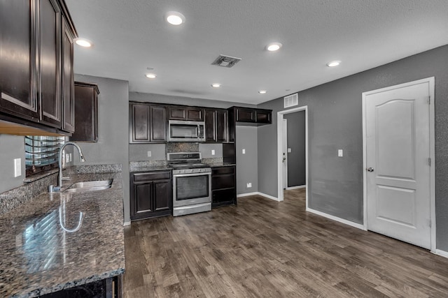 5576 E Burns Ave, Fresno, CA 93727 - kitchen featuring appliances with stainless steel finishes, a sink, dark wood-style floors, dark brown cabinetry, and a textured ceiling