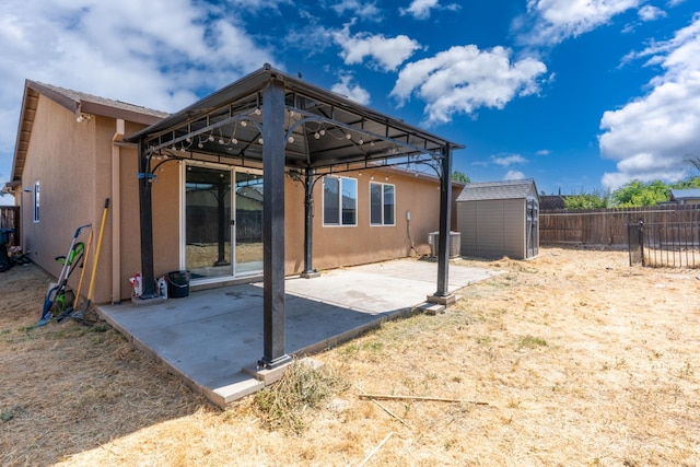 5576 E Burns Ave, Fresno, CA 93727 - rear view of house featuring stucco siding, a patio area, a gazebo, a fenced backyard, and central AC unit