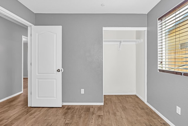 5576 E Burns Ave, Fresno, CA 93727 - unfurnished bedroom featuring a closet, wood finished floors, and baseboards