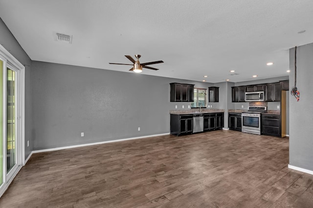 5576 E Burns Ave, Fresno, CA 93727 - unfurnished living room with a ceiling fan, dark wood finished floors, baseboards, a sink, and recessed lighting