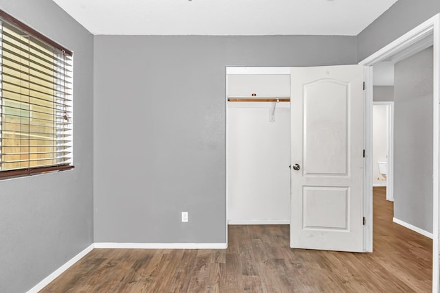5576 E Burns Ave, Fresno, CA 93727 - unfurnished bedroom featuring a closet, wood finished floors, and baseboards