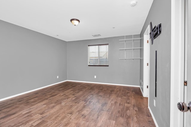 5576 E Burns Ave, Fresno, CA 93727 - spare room with a smoke detector, wood finished floors, and baseboards