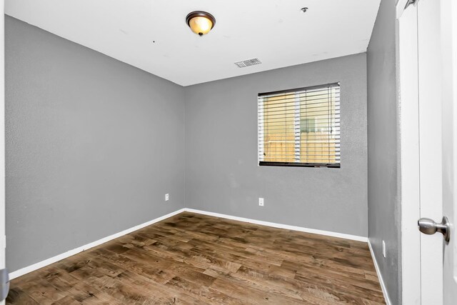 5576 E Burns Ave, Fresno, CA 93727 - unfurnished room featuring wood finished floors, baseboards, and a pendent fire sprinkler