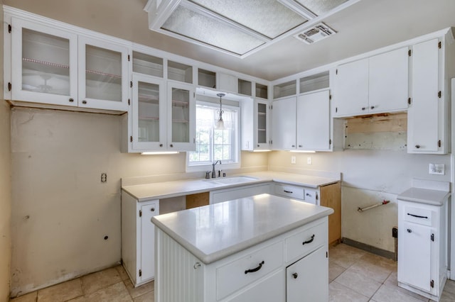724 W Harvard Ave, Fresno, CA 93705 - kitchen with a sink, glass insert cabinets, white cabinetry, light tile patterned floors, and a kitchen island
