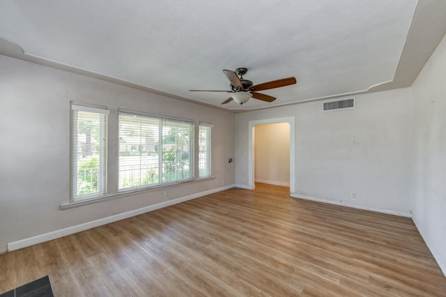 724 W Harvard Ave, Fresno, CA 93705 - spare room with ceiling fan, baseboards, light wood finished floors, and arched walkways